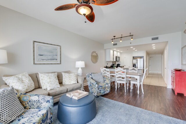 living room with hardwood / wood-style flooring and ceiling fan