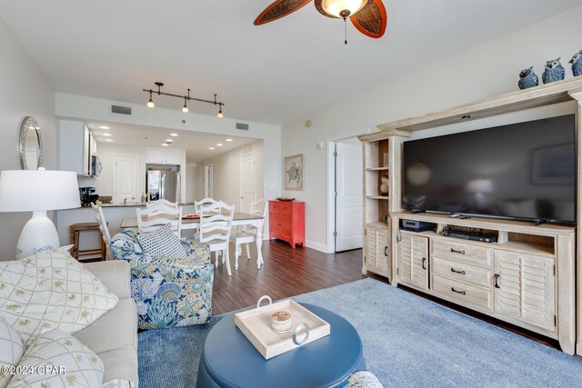 living room featuring dark hardwood / wood-style floors and ceiling fan