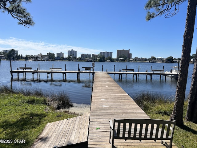 view of dock with a view of city and a water view