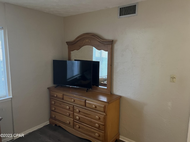 bedroom with baseboards and visible vents