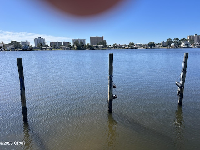 view of dock with a water view and a city view