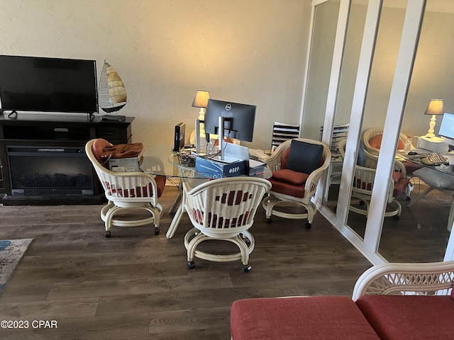 office space with a fireplace and wood finished floors