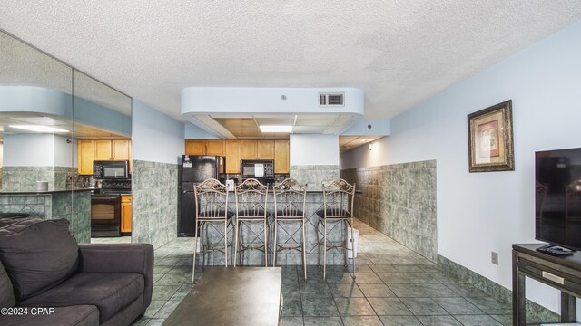 tiled living room with a textured ceiling