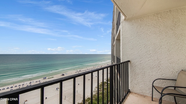 balcony with a water view and a beach view