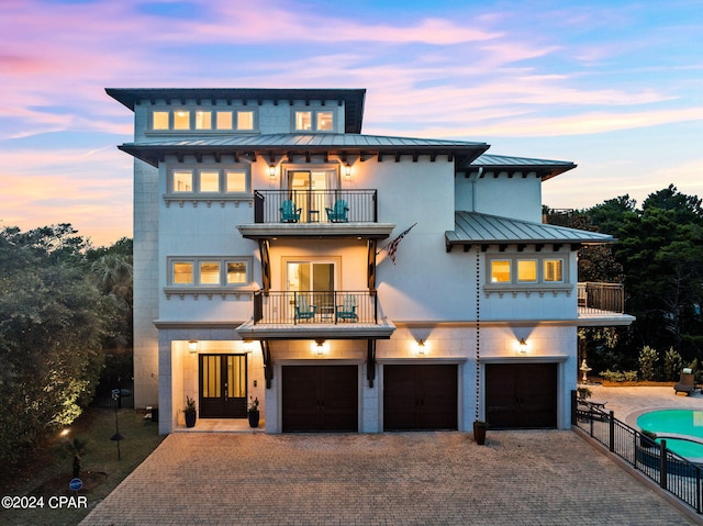 view of front of house featuring a balcony and a garage