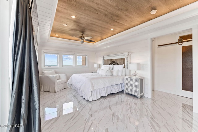 bedroom featuring wood ceiling, ceiling fan, a raised ceiling, and a barn door