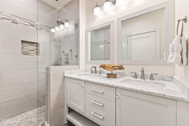 bathroom featuring a tile shower and vanity