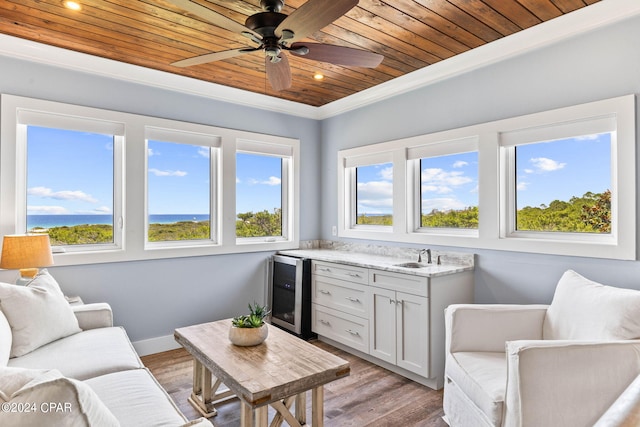 living room featuring light hardwood / wood-style flooring, beverage cooler, ceiling fan, and wooden ceiling