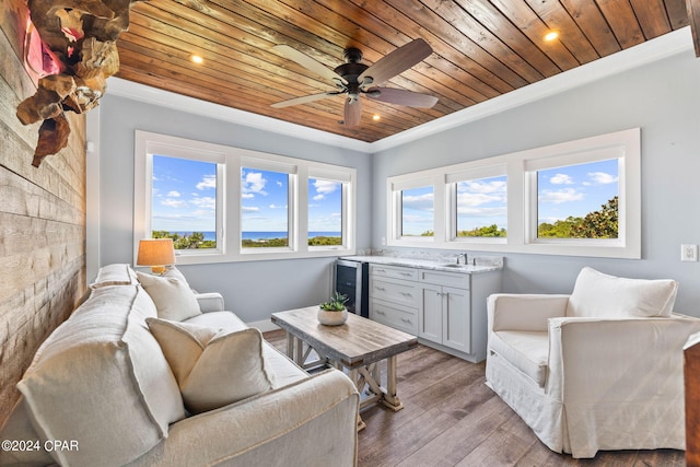 living room with wood ceiling, beverage cooler, ceiling fan, light hardwood / wood-style flooring, and ornamental molding