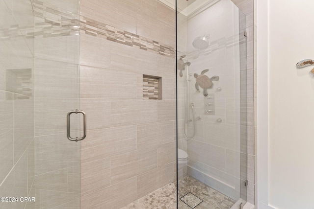 bathroom featuring a shower with door