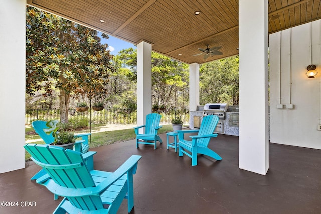 view of patio with exterior kitchen, ceiling fan, and a grill