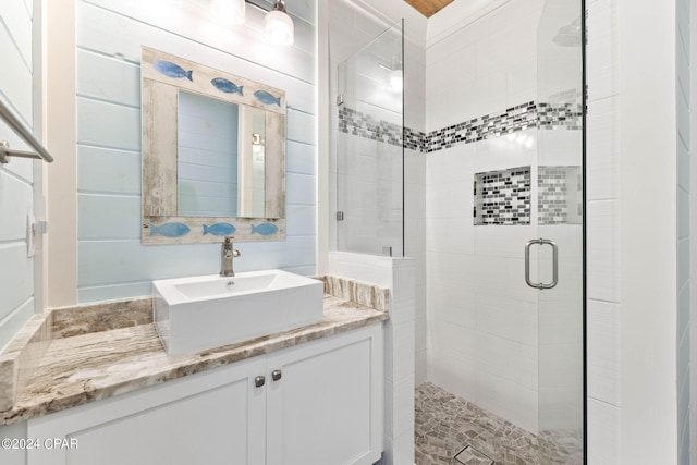 bathroom featuring walk in shower and vanity