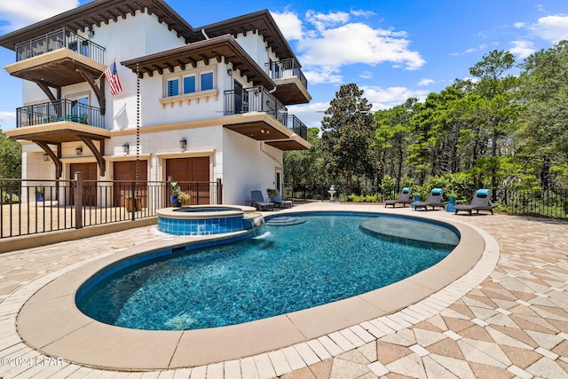 view of pool featuring an in ground hot tub and a patio area