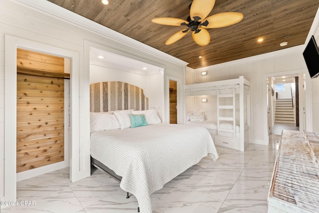 bedroom with wood ceiling, wood walls, ceiling fan, and crown molding