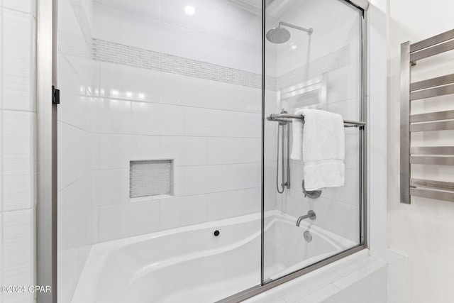 bathroom with shower / bath combination with glass door