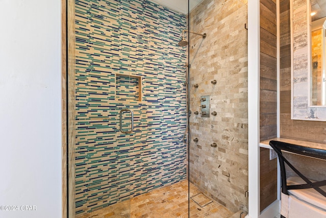 bathroom with a shower with door