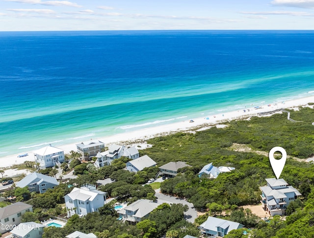 bird's eye view featuring a water view and a beach view