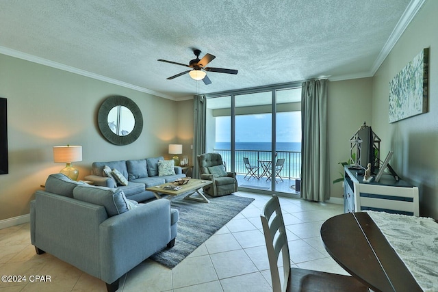 living area featuring a ceiling fan, crown molding, baseboards, and light tile patterned floors