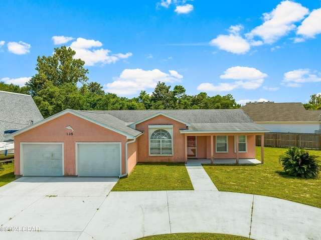 ranch-style house featuring a garage and a front lawn