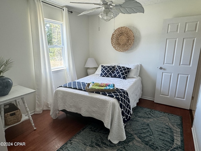 bedroom with dark wood-type flooring and ceiling fan