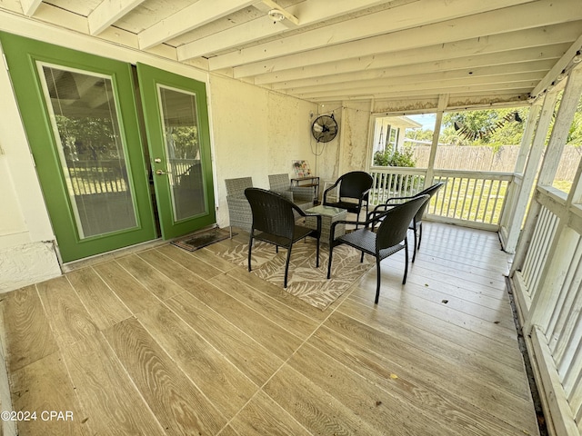 sunroom with beamed ceiling