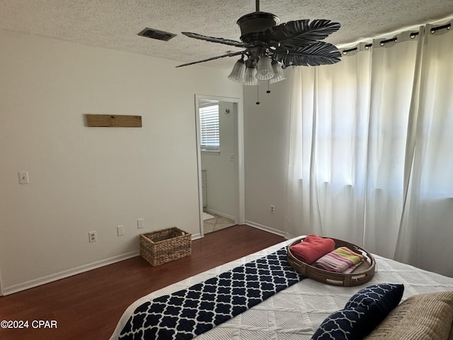 unfurnished bedroom with ceiling fan, dark hardwood / wood-style floors, and a textured ceiling