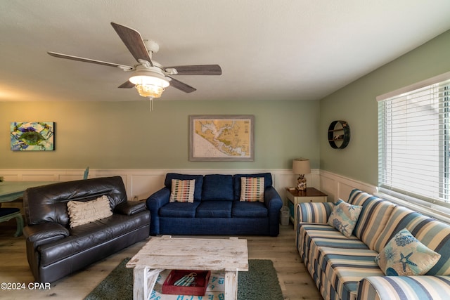 living room featuring light wood-type flooring and ceiling fan