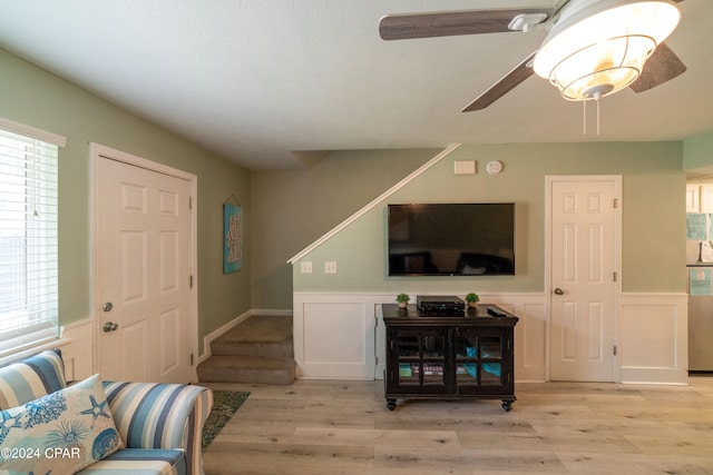 living room with ceiling fan and light hardwood / wood-style floors