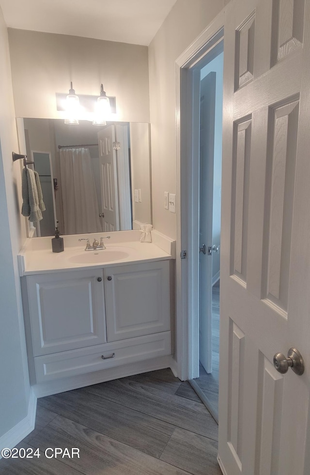 bathroom with vanity and hardwood / wood-style flooring