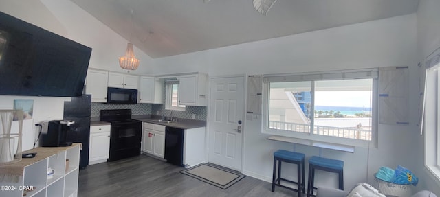 kitchen featuring white cabinetry, black appliances, a healthy amount of sunlight, and backsplash