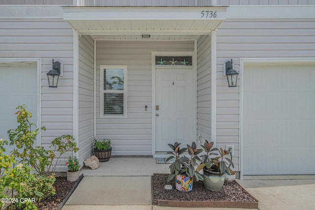 doorway to property featuring a garage