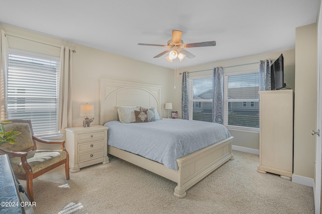 bedroom featuring ceiling fan and light colored carpet