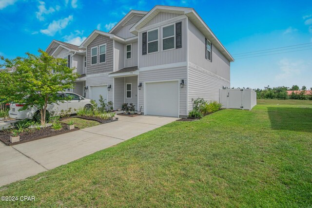 view of front facade with a garage and a front yard