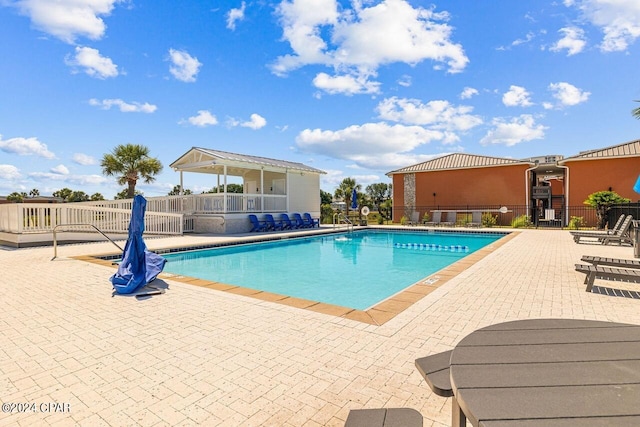 view of swimming pool with a patio