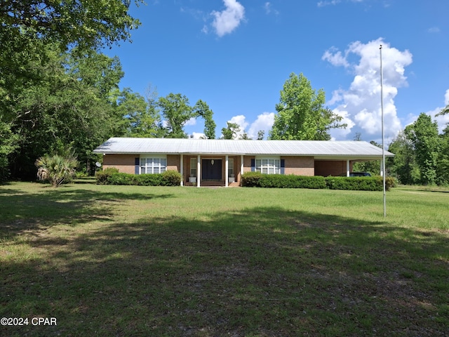 ranch-style home featuring a front yard