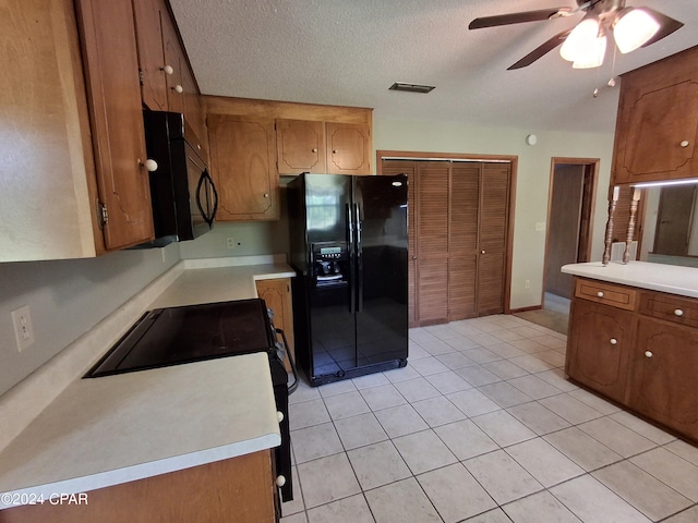 kitchen with ceiling fan, light tile patterned floors, a textured ceiling, and black appliances