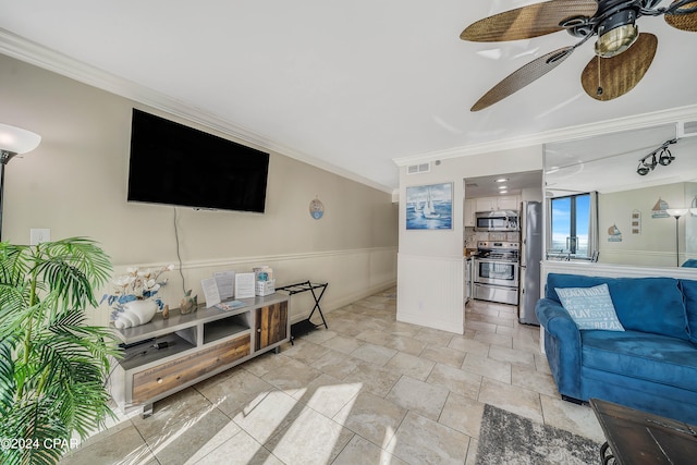 living room with ceiling fan and ornamental molding