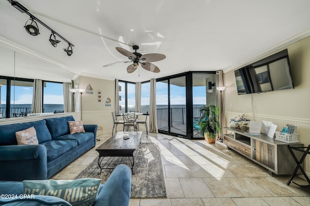 living room featuring a water view, a wall of windows, and a healthy amount of sunlight