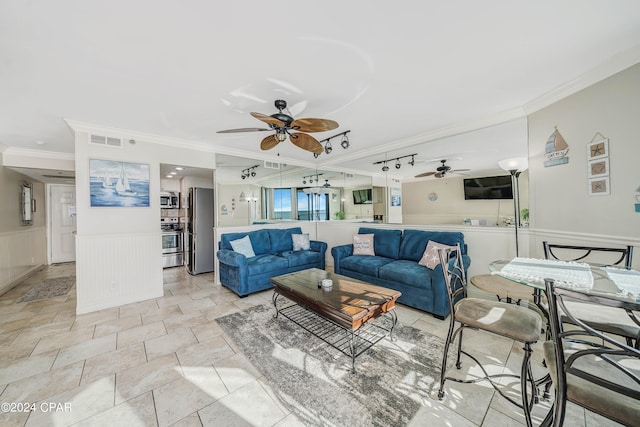 living room featuring ceiling fan and ornamental molding