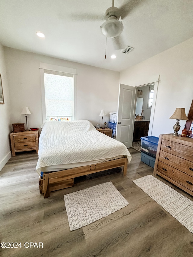 bedroom with ceiling fan and hardwood / wood-style floors