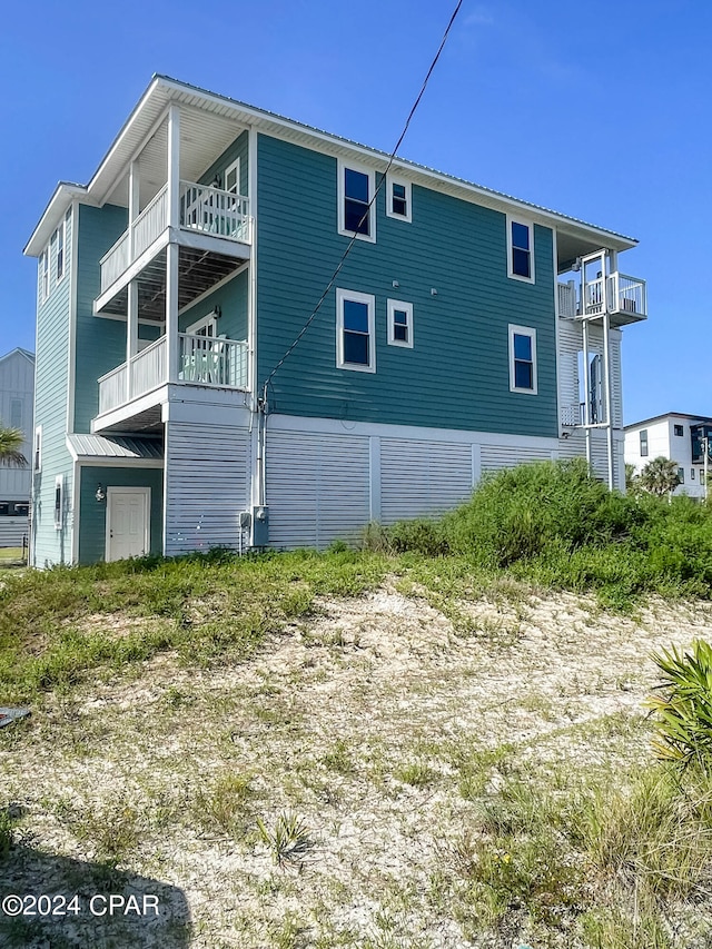 view of side of property with a balcony