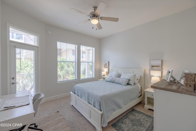 carpeted bedroom featuring ceiling fan and access to exterior