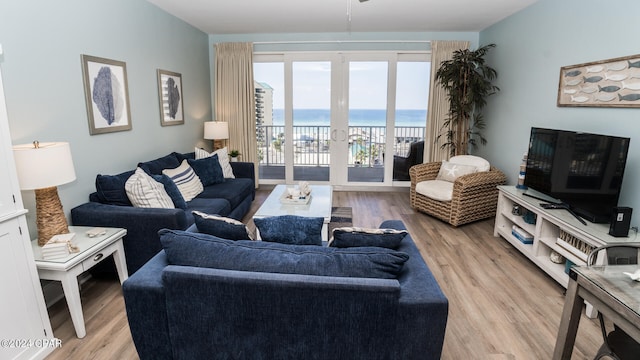 living room with light hardwood / wood-style flooring and french doors