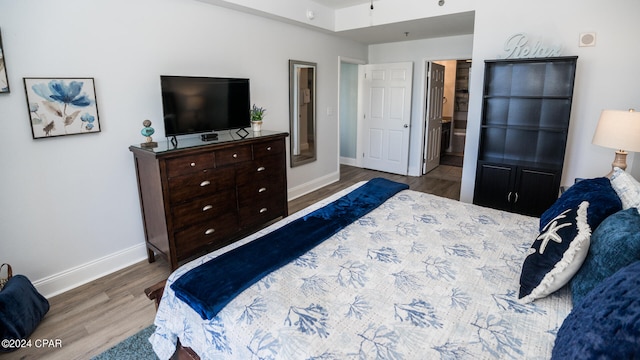 bedroom featuring wood-type flooring and ensuite bathroom