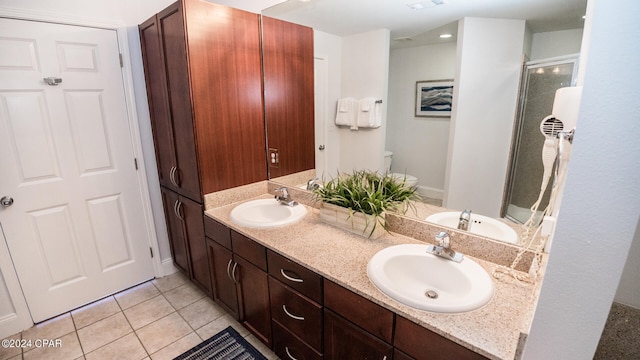 bathroom with tile patterned flooring, vanity, and toilet