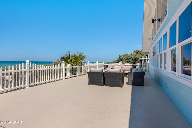 view of patio featuring an outdoor living space and a water view