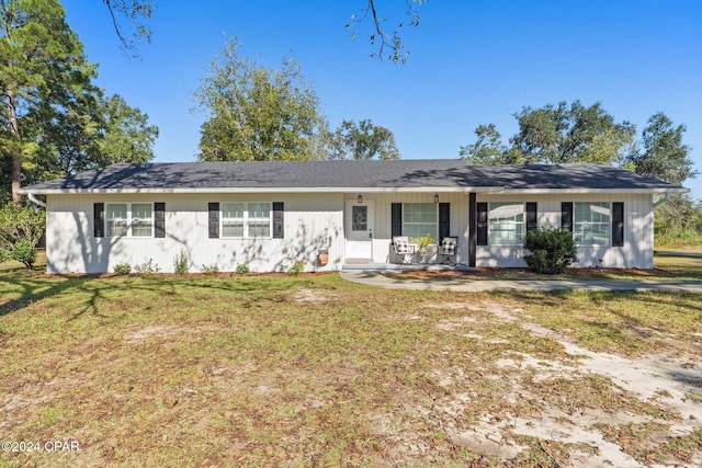 ranch-style home with covered porch and a front lawn