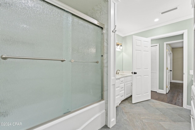 bathroom with crown molding, vanity, wood-type flooring, and combined bath / shower with glass door