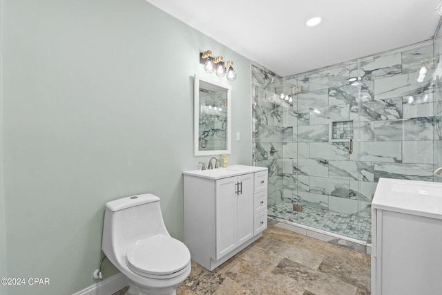 bathroom with vanity, toilet, and tiled shower