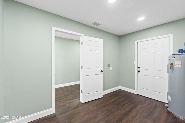 entryway featuring dark hardwood / wood-style floors and water heater